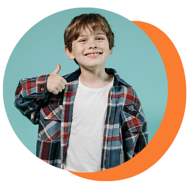 Boy in plaid shirt giving a thumbs up, smiling, against a blue background with an orange circle.