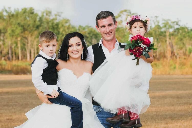 A Bride and Groom Are Posing for a Picture With Their Two Children — Just Formals in Winnellie, NT