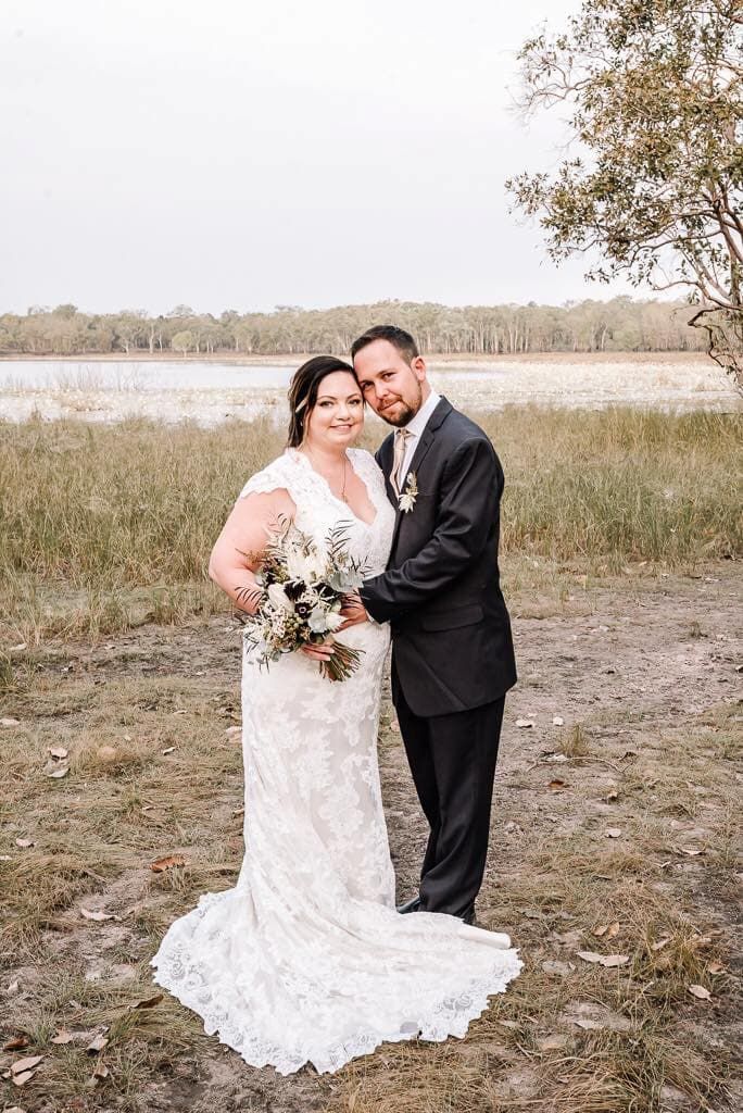 A Bride and Groom Are Posing for a Picture in a Field — Just Formals in Winnellie, NT