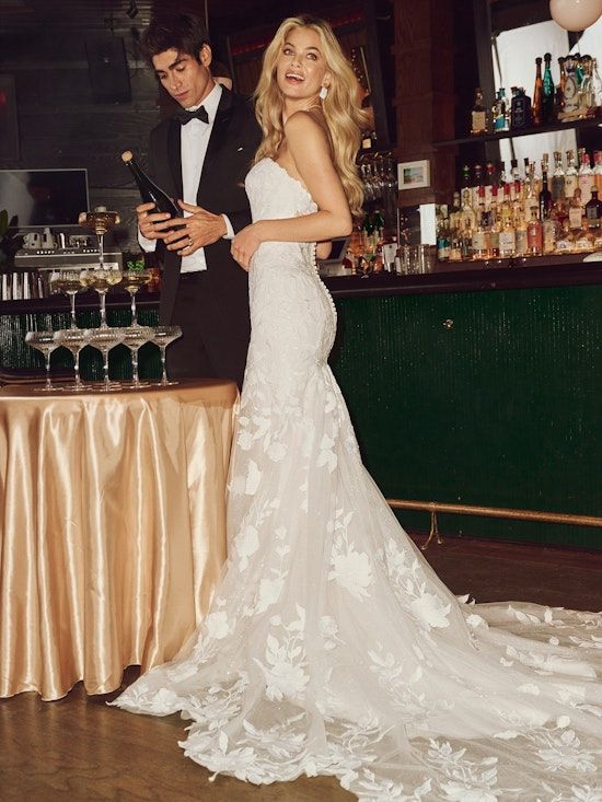 A Bride Stands Beside a Man Opening Champagne — Just Formals in Winnellie, NT