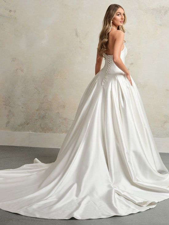 Woman in a Strapless Wedding Dress, Standing Next to a Doorway in an Outdoor Setting — Just Formals in Winnellie, NT