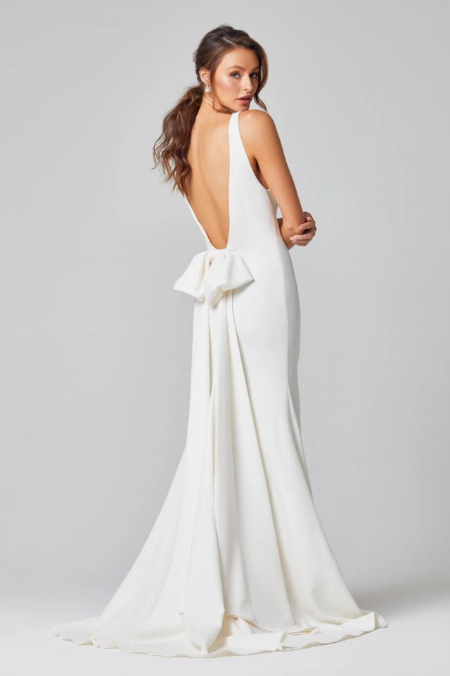 A Woman in an Elegant Backless White Gown With a Bow — Just Formals in Winnellie, NT