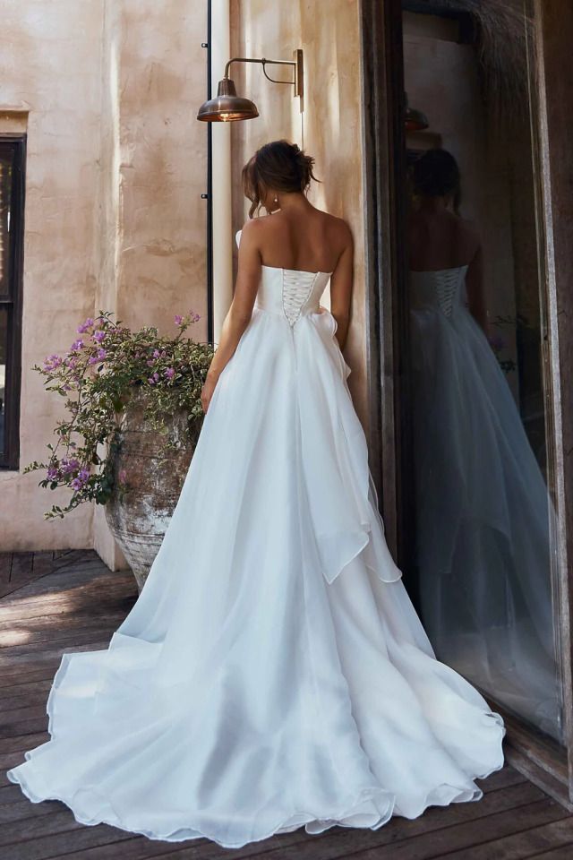 A Woman in Wedding Gown Stands on a Wooden Deck — Just Formals in Winnellie, NT