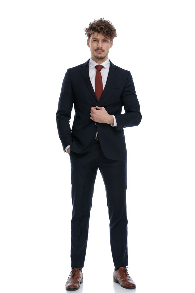 Man in a Navy Suit and Red Tie, Buttoning His Jacket — Just Formals in Winnellie, NT