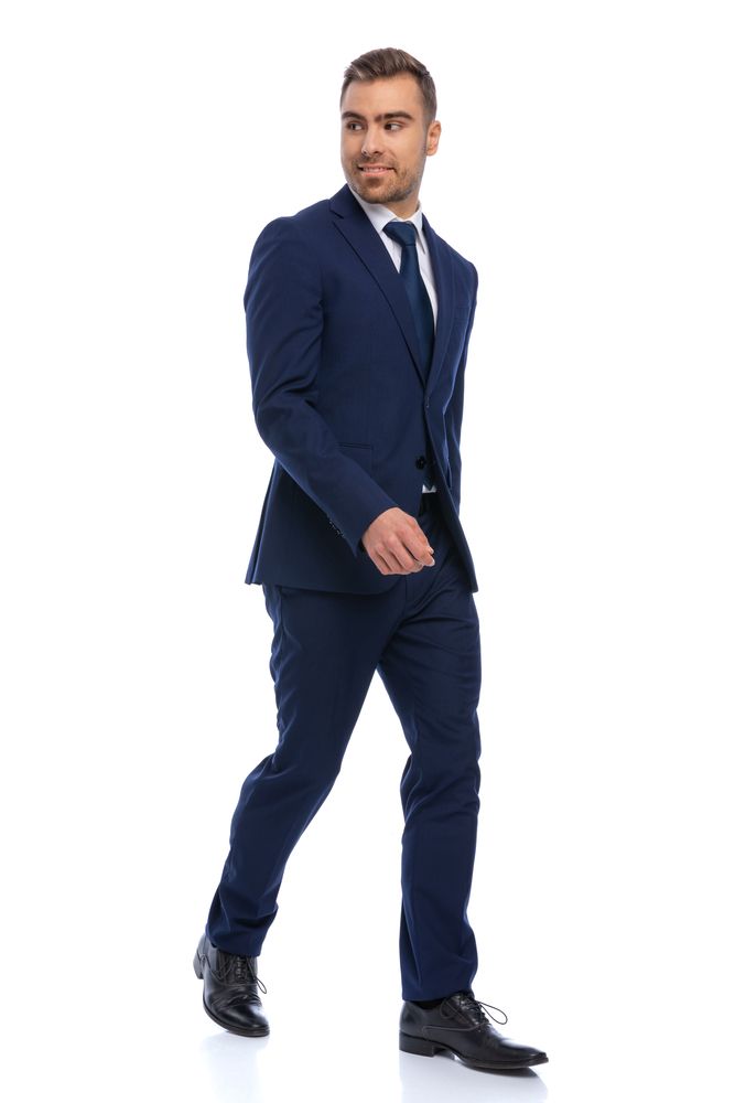 Man in a Navy Blue Suit Walking and Looking Over His Shoulder — Just Formals in Winnellie, NT
