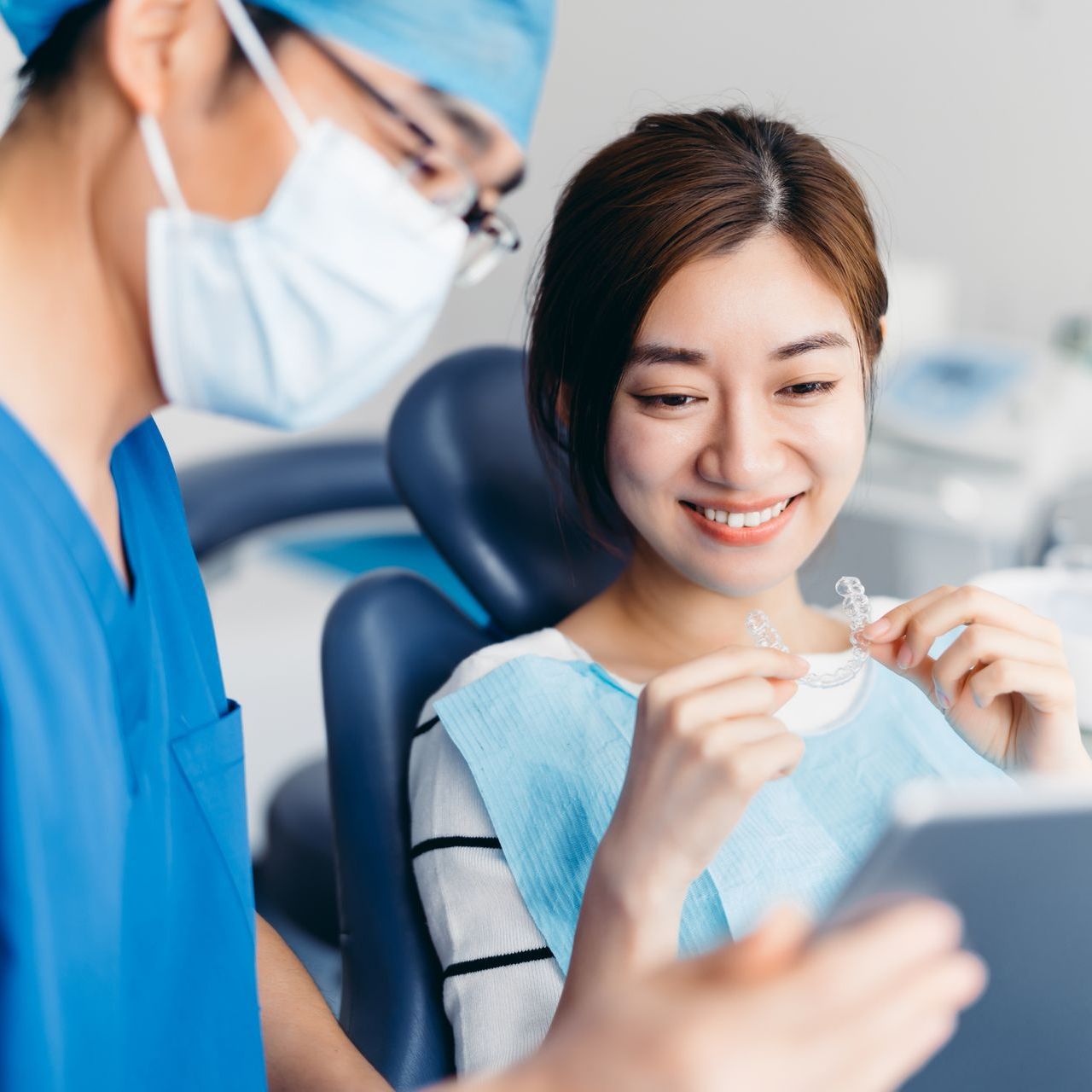 Dentist cleaning patient teeth