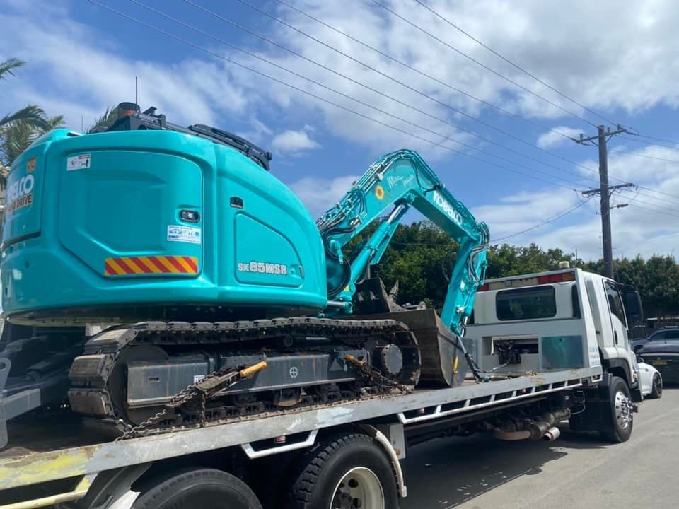 Excavator Being Transported by Truck — Port Macquarie Tilt Tray Towing in Telegraph Point, NSW