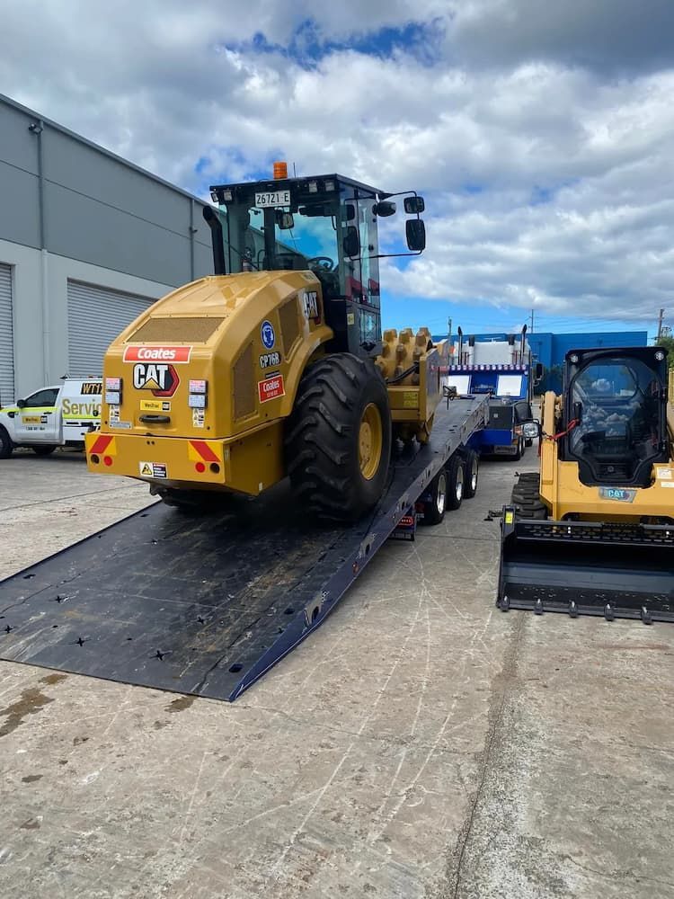Loading Heavy CAT Loader on a Tow Truck — Port Macquarie Tilt Tray Towing in Wauchope, NSW