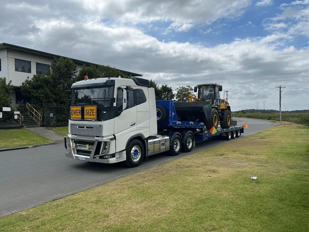White Oversized Truck Transporting Equipment — Port Macquarie Tilt Tray Towing in Telegraph Point, NSW