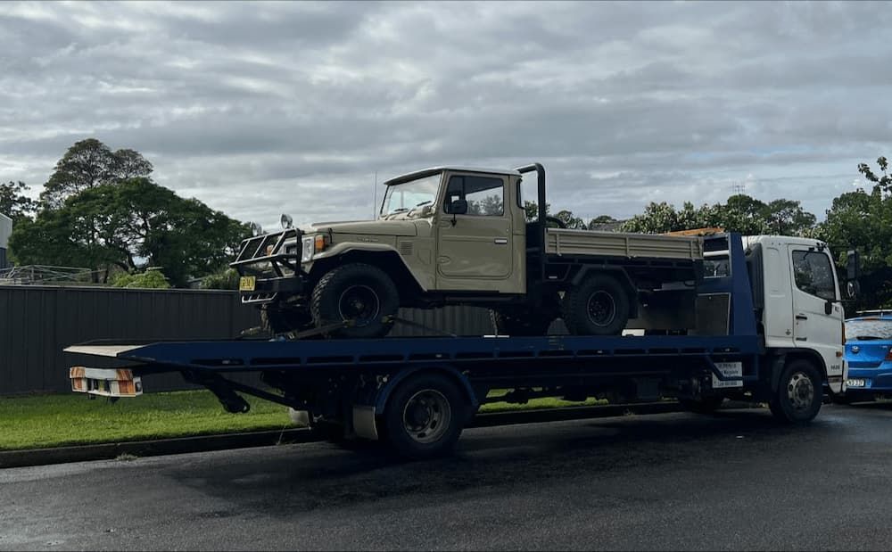 Ute Truck Mounted on a Tow Truck For Transportation — Port Macquarie Tilt Tray Towing in Telegraph Point, NSW