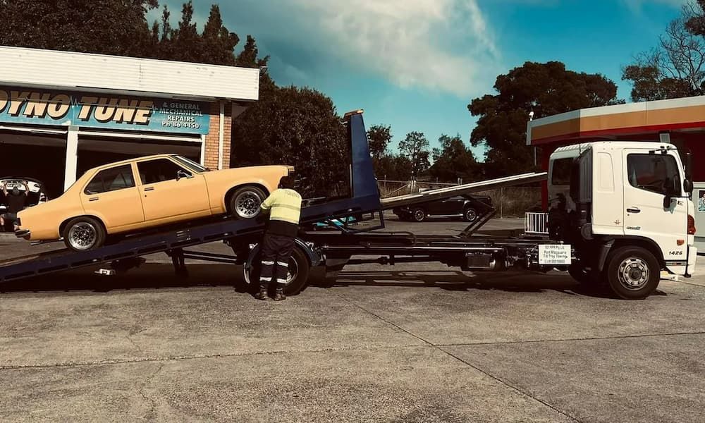 Man Towing a retro car with a Tow Truck — Port Macquarie Tilt Tray Towing in Wauchope, NSW