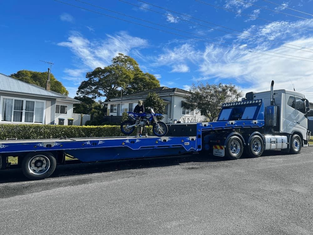 Motorbike Loaded Onto a Tow Truck — Port Macquarie Tilt Tray Towing in Telegraph Point, NSW