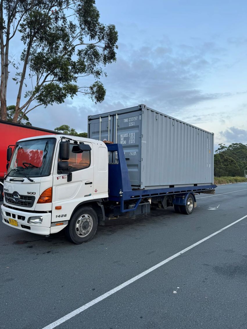 A Tow Truck With a Container on the Back — Port Macquarie Tilt Tray Towing in Telegraph Point, NSW