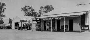 It is a black and white photo of a gas station.