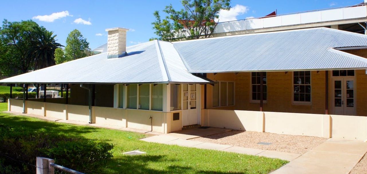 A large yellow house with a white roof