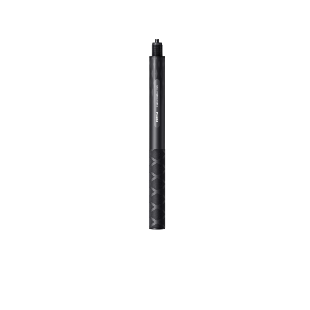 A black pen is sitting on a white surface.