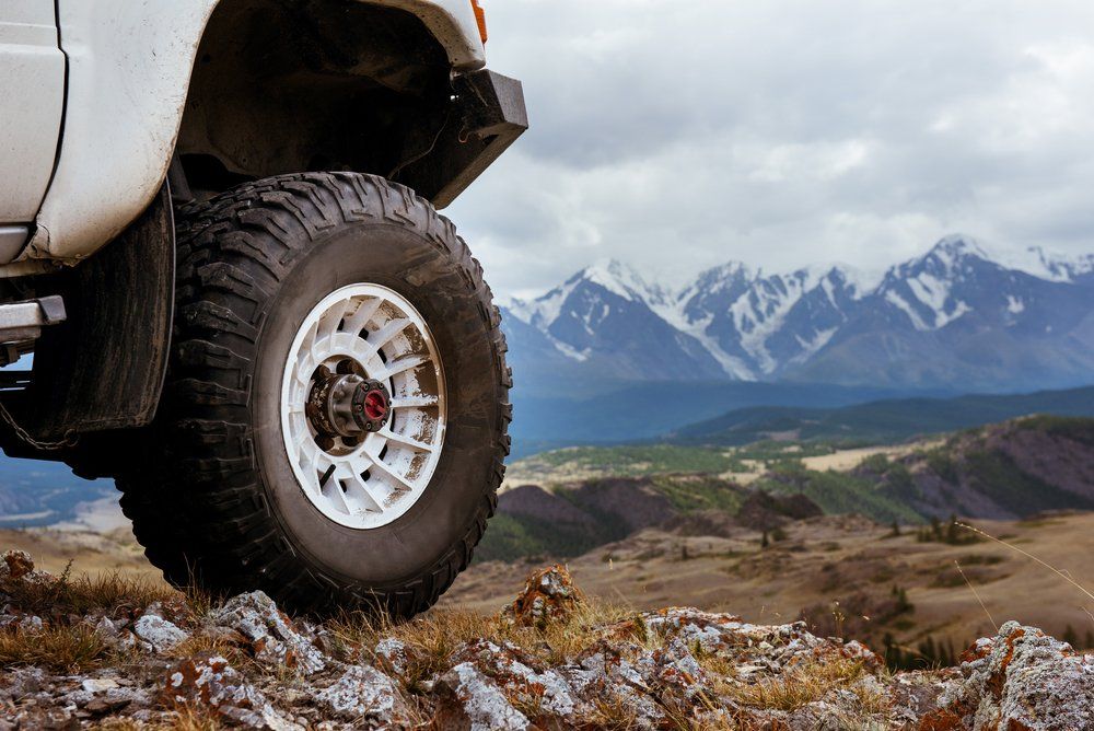 Big Car Wheel is Standing on the Rocks — Complete Tyre Management Services in Paget, QLD