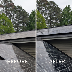 Solar panels on a house roof beneath trees, with one panel partially detached at the edge.