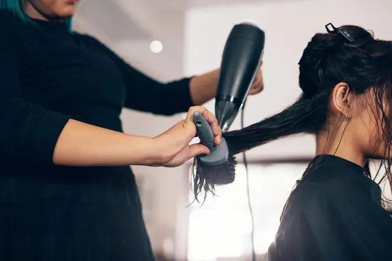 Close Up Of Hair Stylist Using Dryer — Silver Sping, MD — Montgomery Beauty School