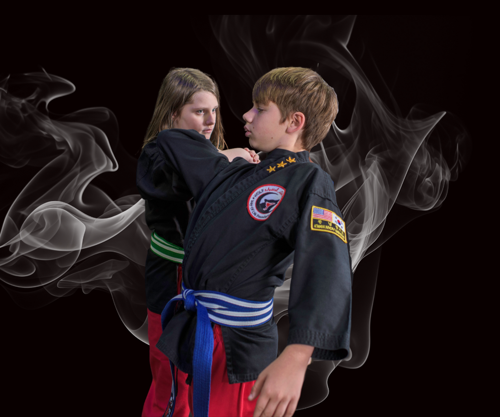 A boy and a girl are practicing martial arts with smoke behind them