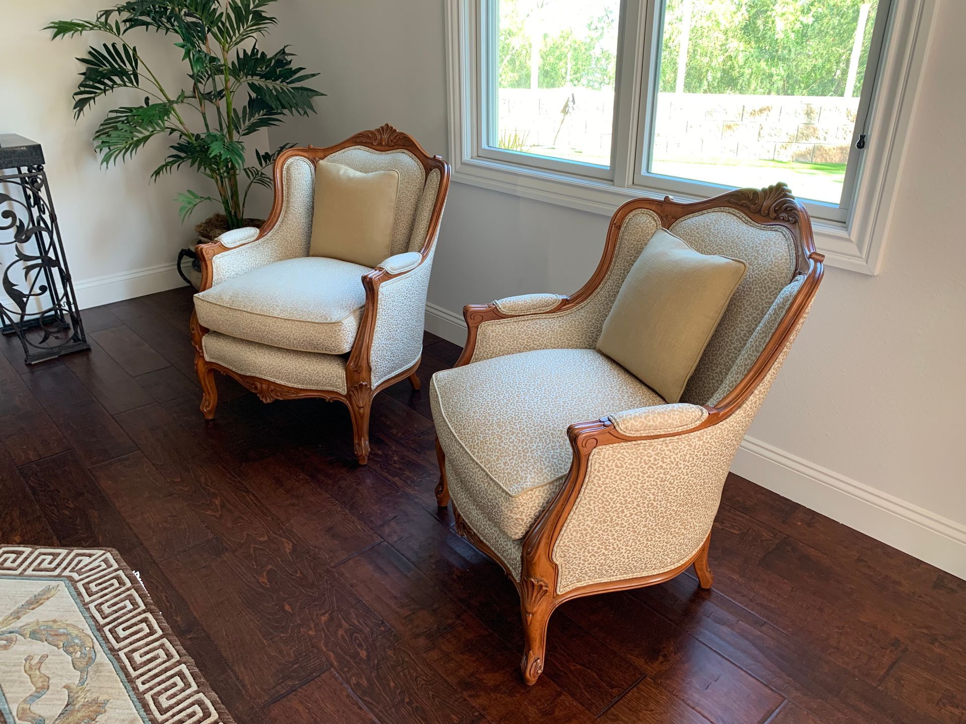 Two chairs are sitting in a living room next to a window.