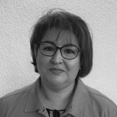 Una fotografía en blanco y negro de una mujer que lleva gafas y una camisa.