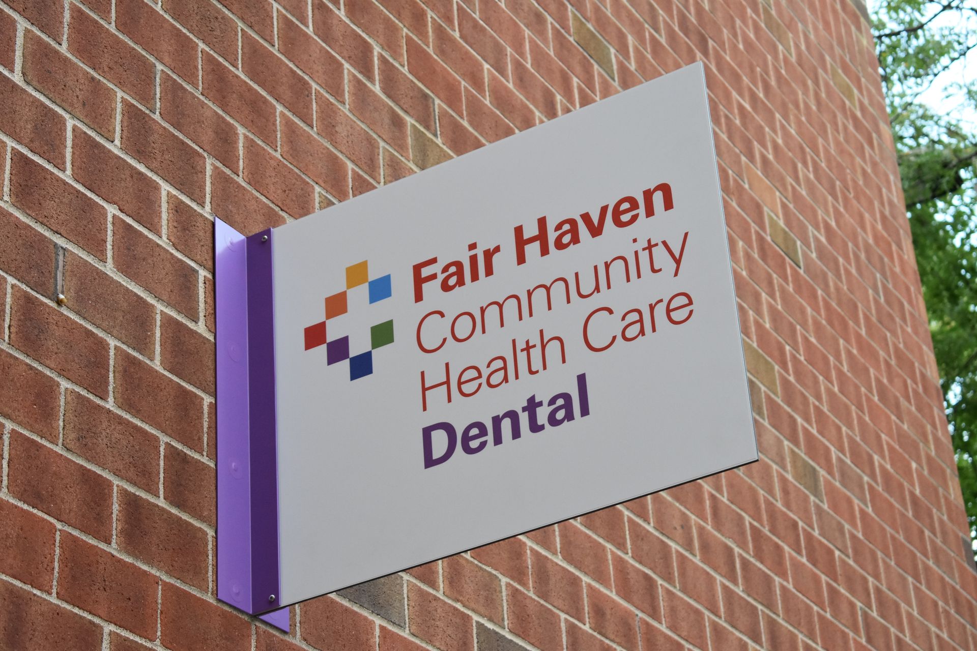 Fair Haven Community Health Care Dental sign on brick building
