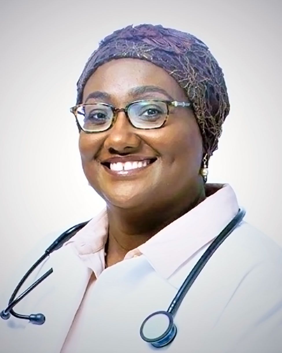 Smiling doctor in glasses and headscarf, wearing a white coat with a stethoscope