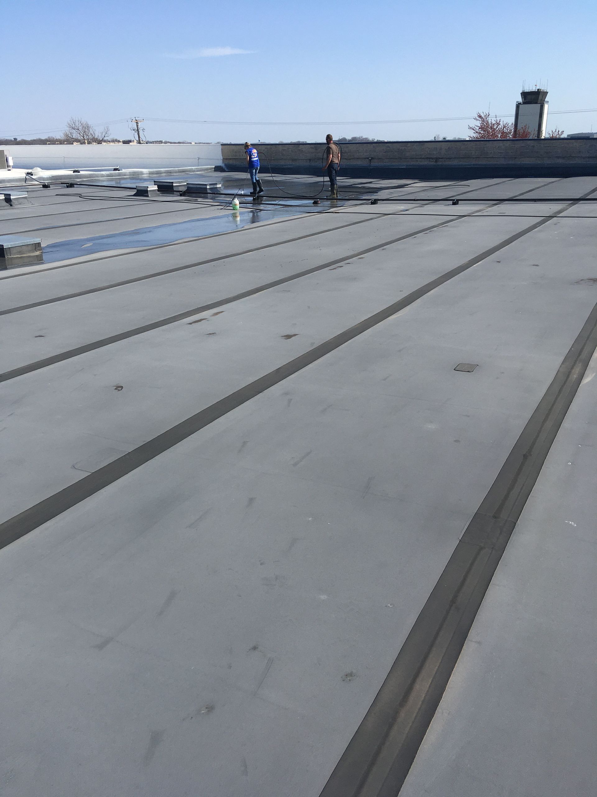 A roof with a few people standing on it