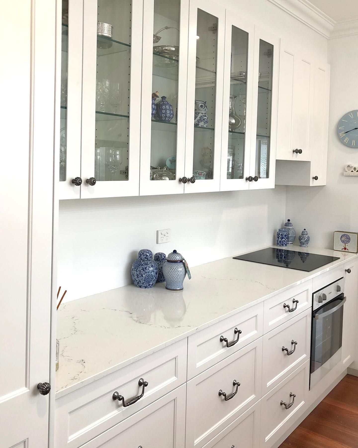 A Kitchen with White Cabinets and A Stove Top Oven — Inovative Interiors In Cardiff, NSW