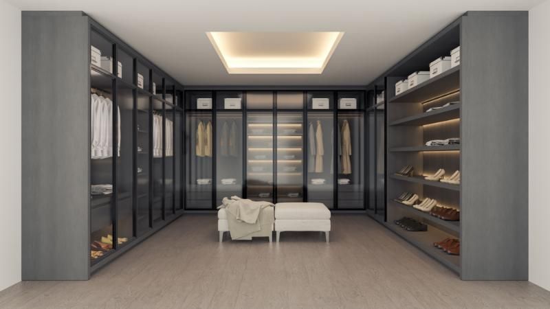 A Large Walk-In Closet with Lots of Shelves and A Chair — Inovative Interiors In Cardiff, NSW