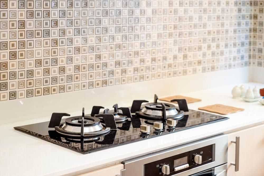 A Stove Top Oven Is Sitting on Top of A Stove in A Kitchen — Inovative Interiors In Cardiff, NSW