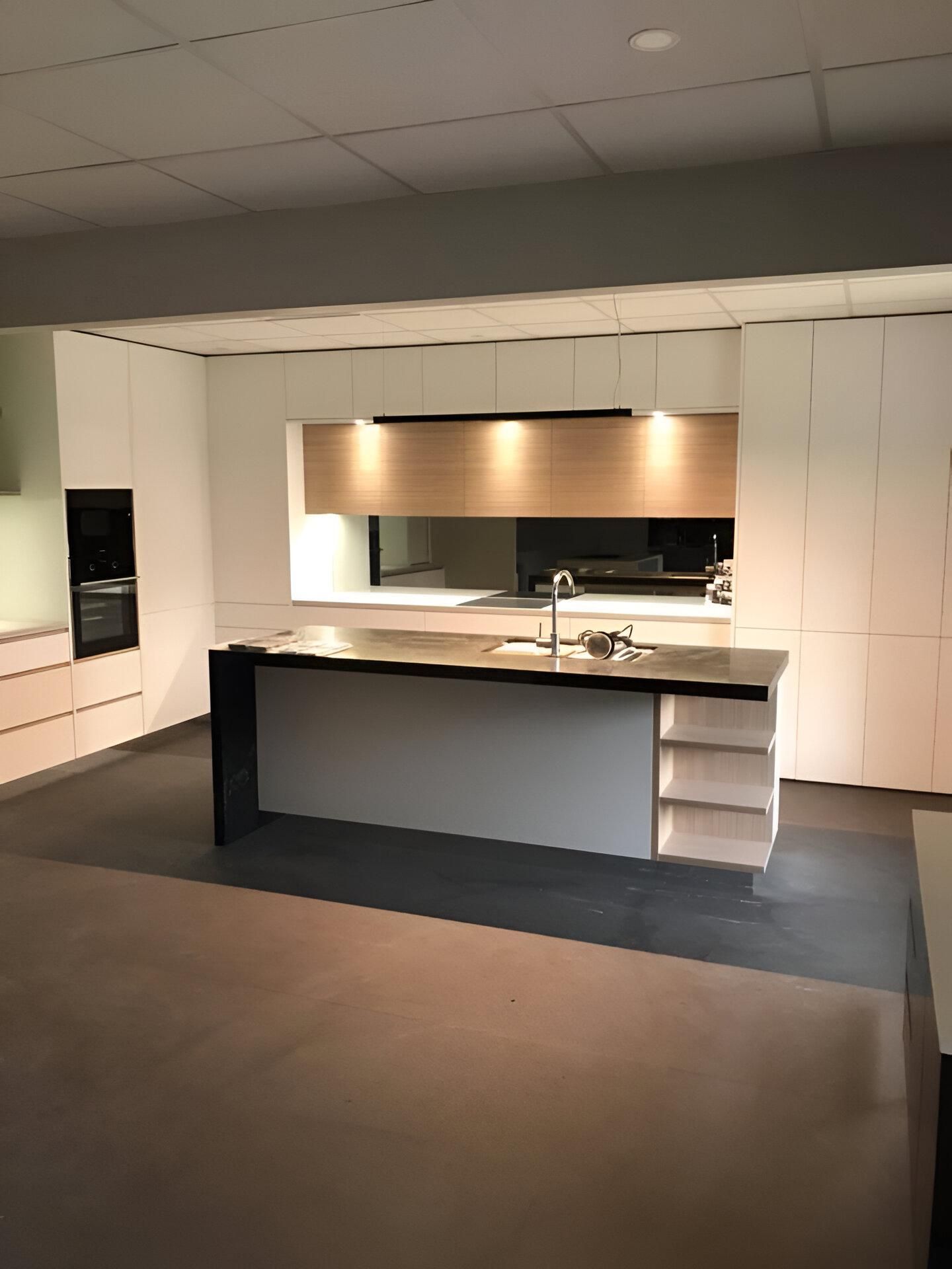 An Empty Kitchen with A Large Island in The Middle — Inovative Interiors In Cardiff, NSW