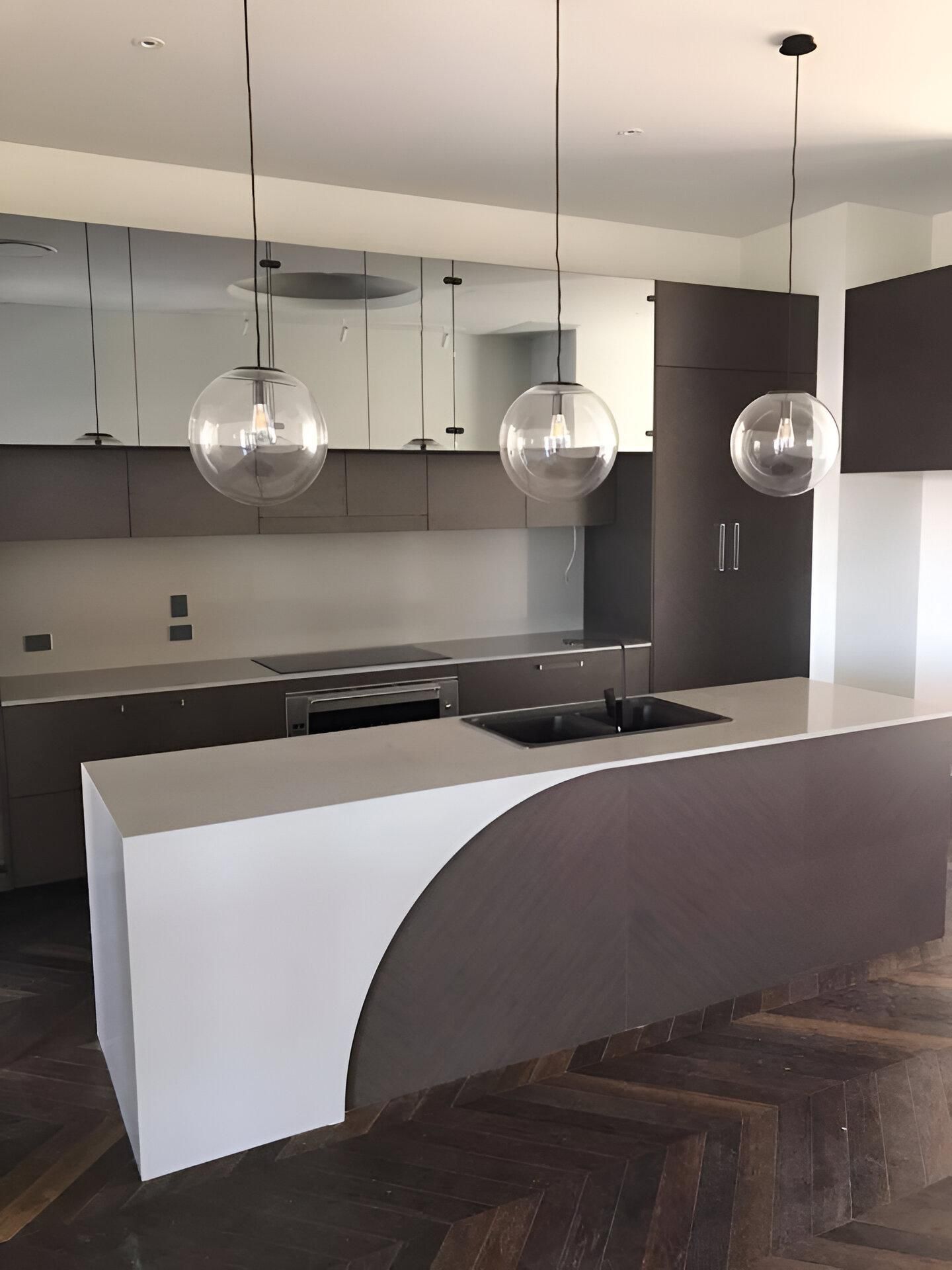 A Kitchen with A Large Island and A Stove Top Oven — Inovative Interiors In Maitland, NSW