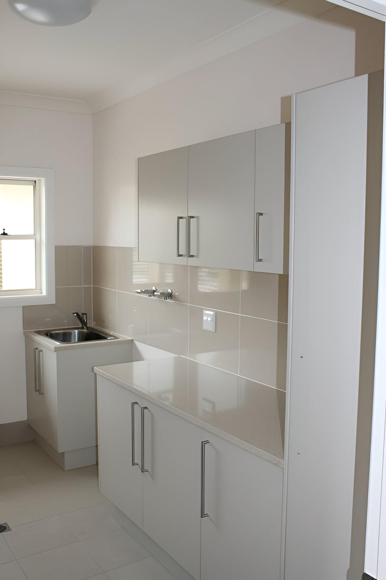 A Kitchen with White Cabinets and A Sink — Inovative Interiors In Maitland, NSW