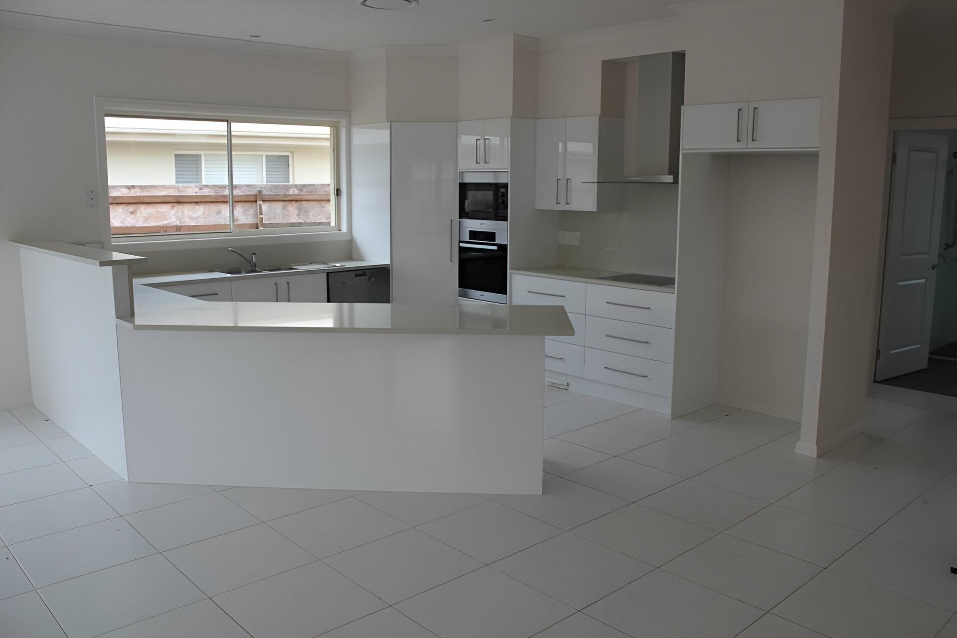 A Kitchen with White Cabinets and Stainless Steel Appliances — Inovative Interiors In Maitland, NSW