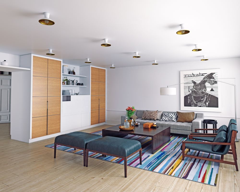 A Living Room with A Couch, Chairs, Ottomans and A Rug — Inovative Interiors In Cardiff, NSW