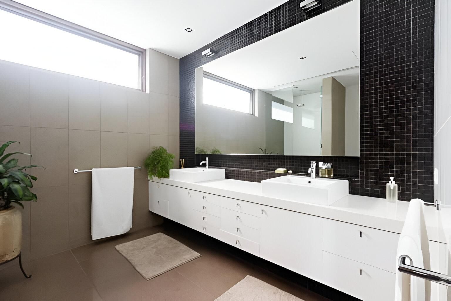 A Bathroom with Two Sinks and A Large Mirror — Inovative Interiors In Cardiff, NSW