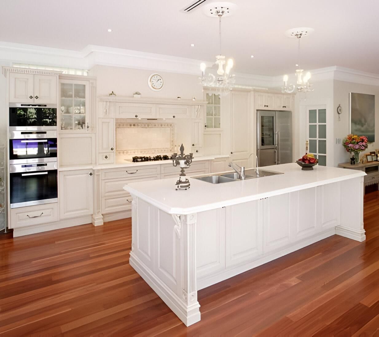 A Kitchen with White Cabinets and A Large Island — Inovative Interiors In Cardiff, NSW