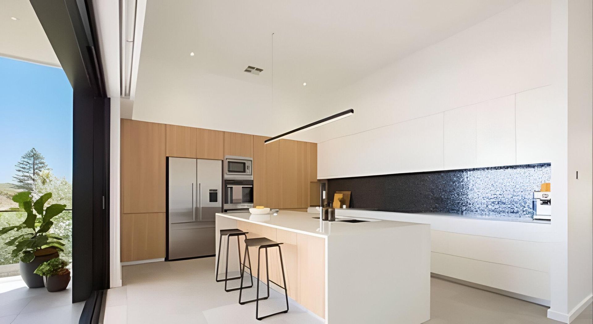 A Modern Kitchen with Stainless Steel Appliances and A Large Island — Inovative Interiors In Cardiff, NSW
