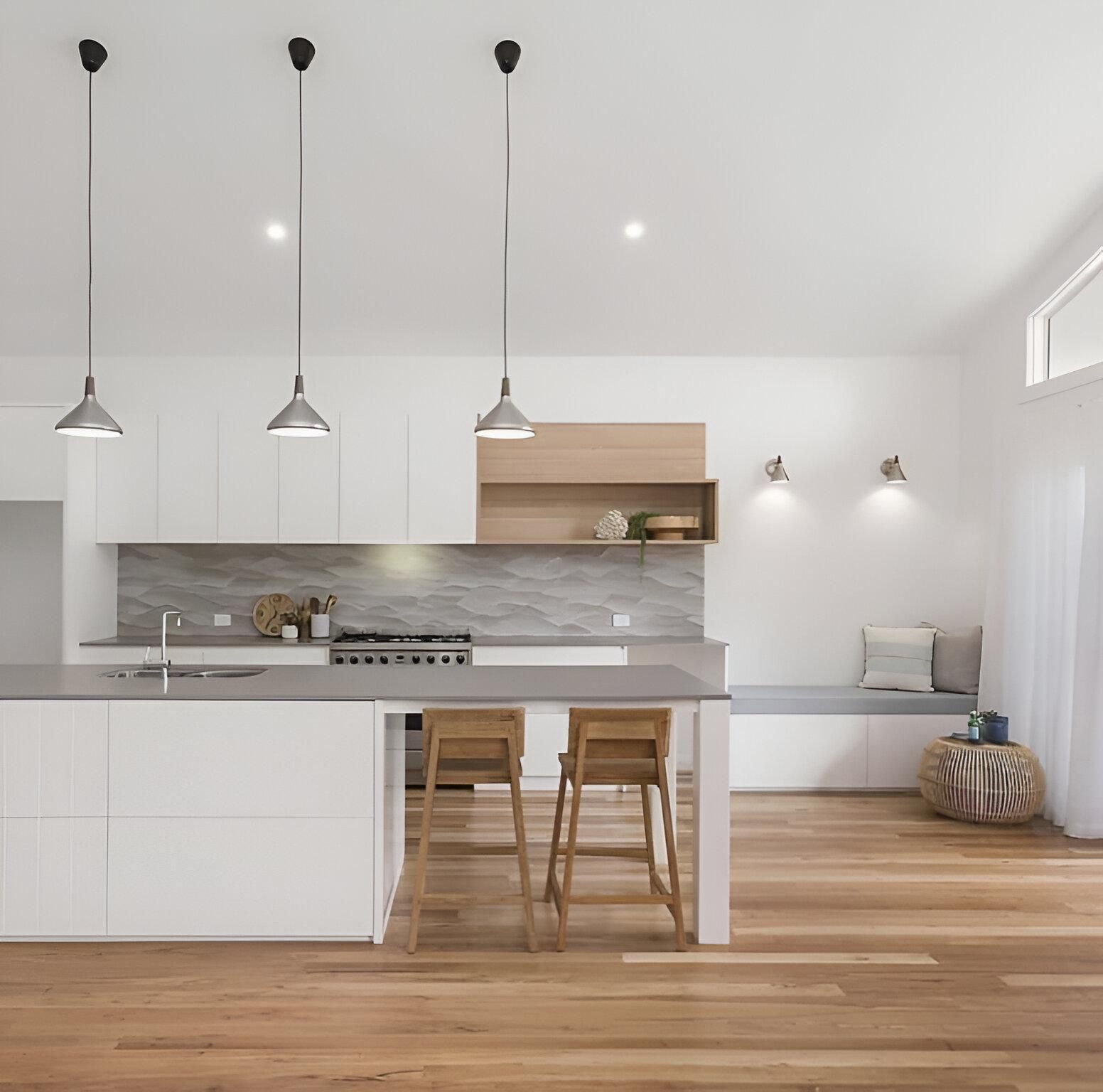 A Kitchen with White Cabinets and Wooden Floors — Inovative Interiors In Cardiff, NSW