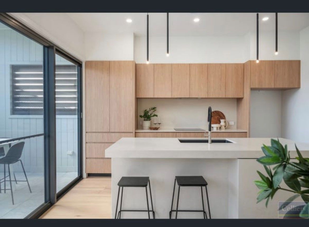 A Kitchen with Wooden Cabinets, a Sink, and A Stove Top Oven — Inovative Interiors In Cardiff, NSW