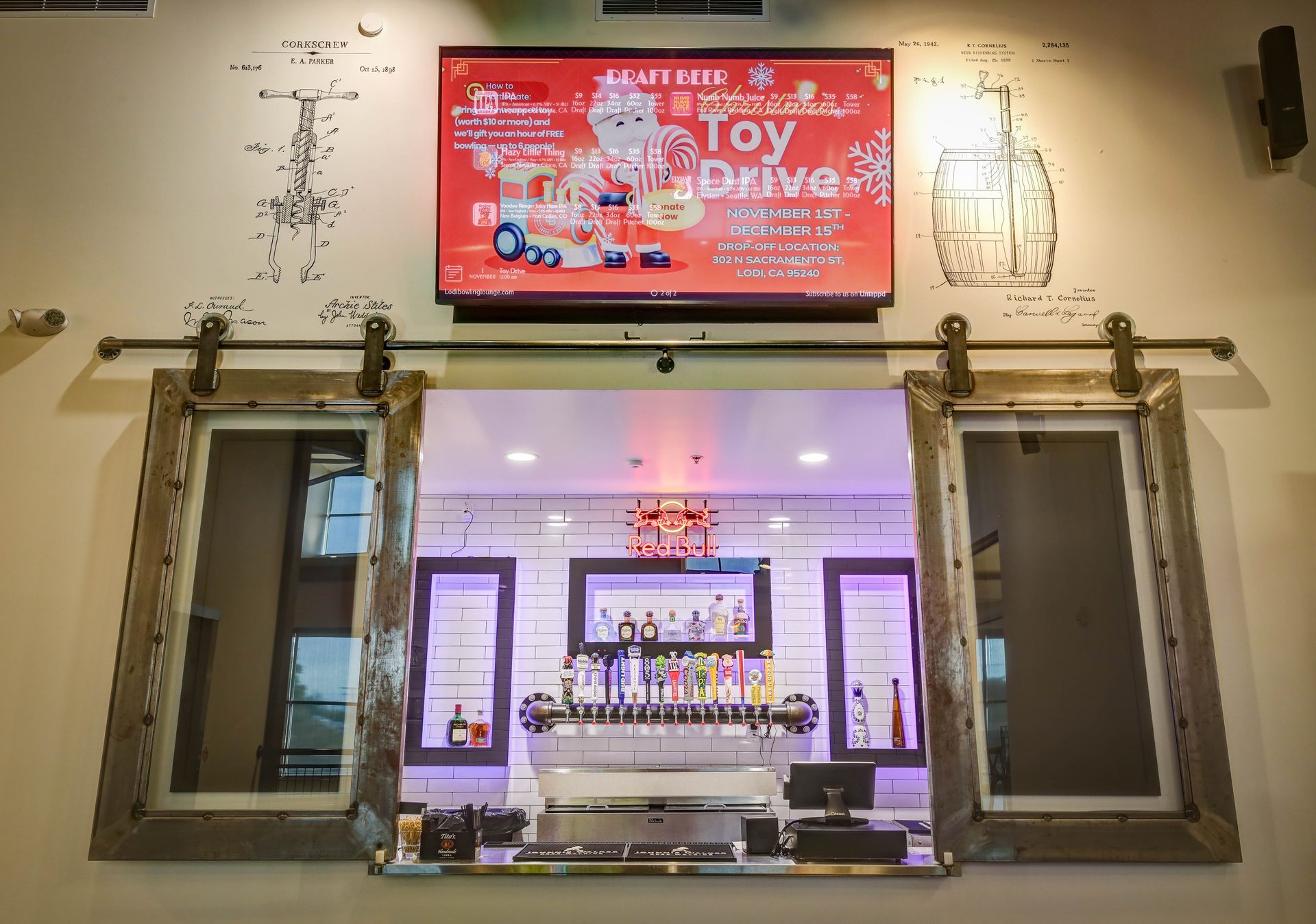 Interior view of a toy-themed store display with a red TV sign, framed windows, and colorful items inside.