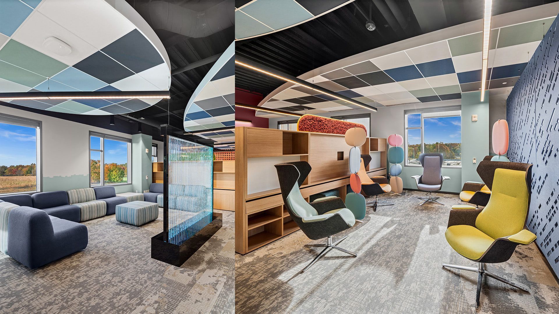 Modern office lounge with colorful chairs, couches, desks, and large windows under a geometric ceiling