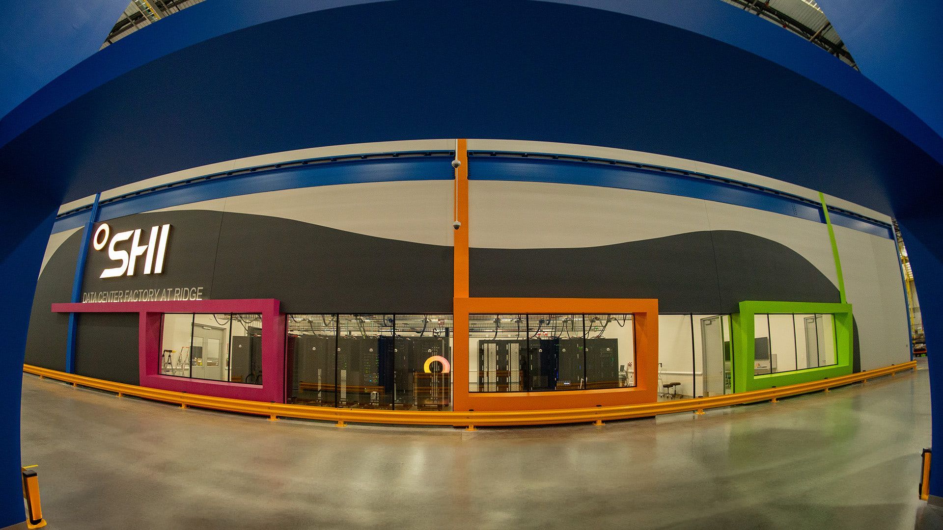 SHI Data Center Factory at Ridge Road — Piscataway, NJ
Wide-angle interior shot showing the bold wall of symbolic viewfinders, colorful elements, the clear raised floor panels, and the under-floor lighting.