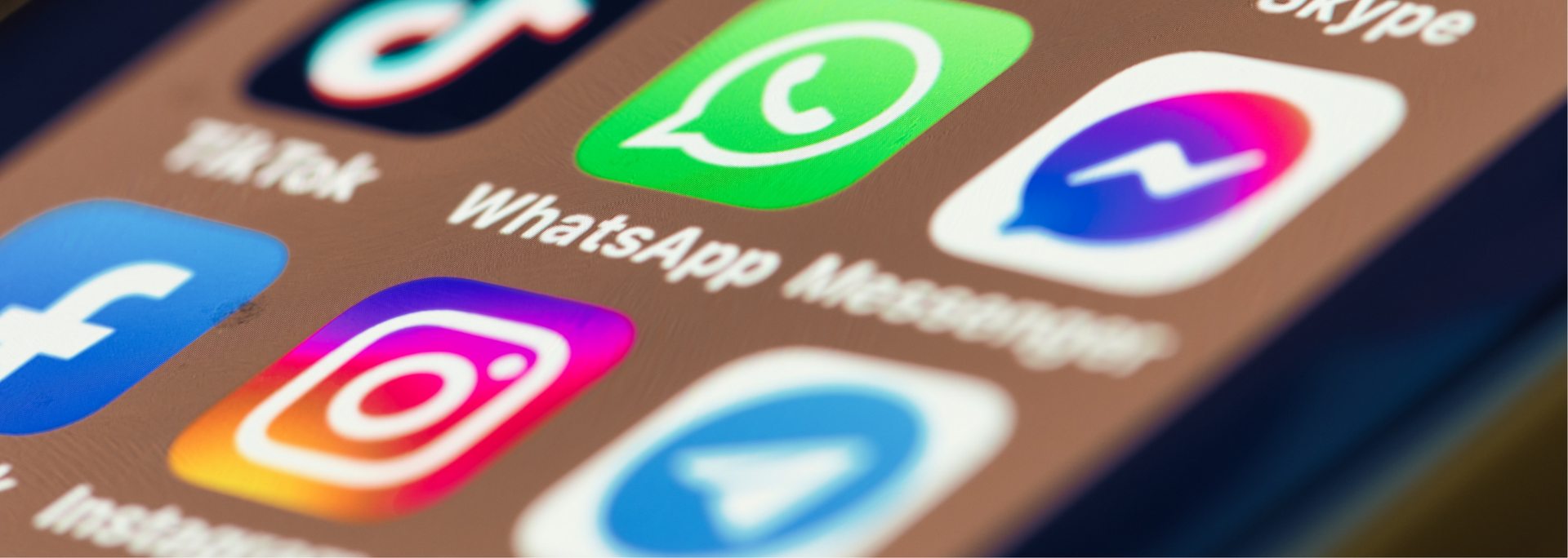 Close-up of social media app icons on a smartphone screen, including TikTok, WhatsApp, Messenger, and Instagram.