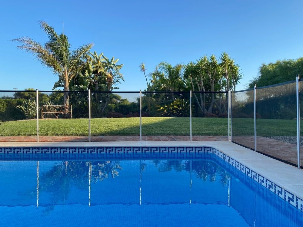 A Large Swimming Pool With A Fence Around It — Solitary Island Pools in Bellingen, NSW