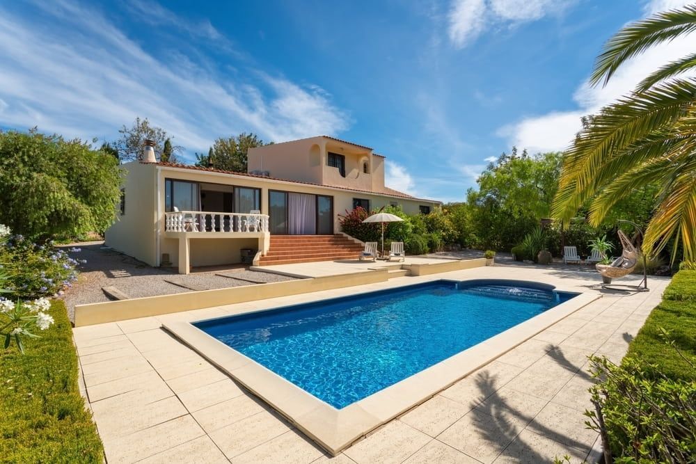 A Large House With A Large Swimming Pool In Front Of It — Solitary Island Pools in Bellingen, NSW