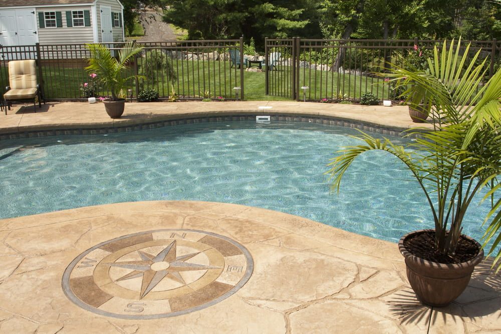 A Swimming Pool With A Compass Design On The Concrete — Solitary Island Pools in Grafton, NSW