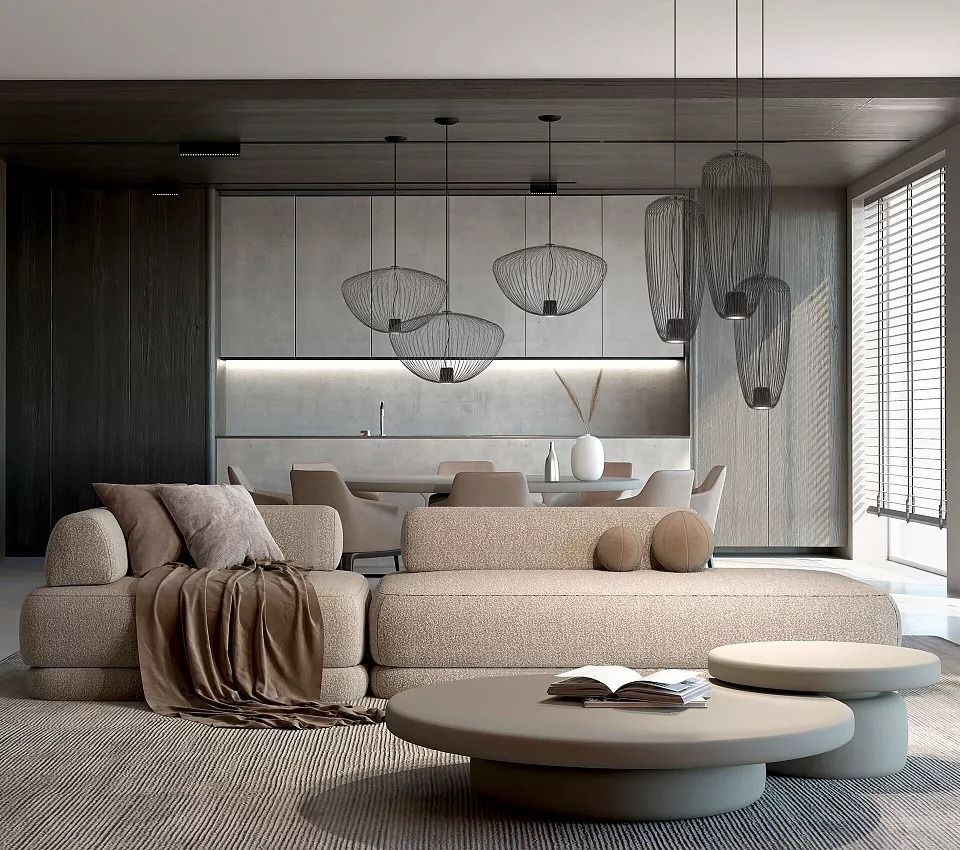 Soggiorno moderno e minimalista con divani curvi beige, tavolini rotondi, lampade a sospensione e finestre a tutta altezza.
